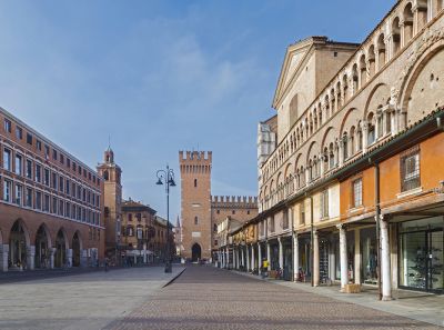 The arcade of medieval shops leaning against Ferrara Cathedral.